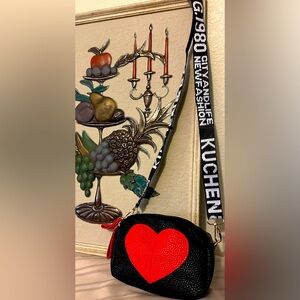 NWOT Kuchen black purse with red heart an adjustable crossbody to shoulder hold.
